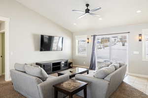 Living room with ceiling fan, lofted ceiling, light tile patterned flooring, and recessed lighting