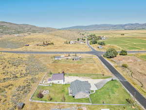 Aerial view of property's location featuring rural landscape and a mountain backdrop