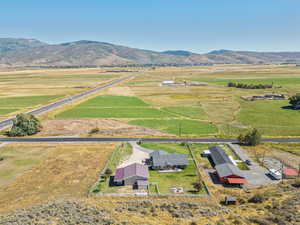 Aerial overview of property's location with rural landscape and a mountain backdrop