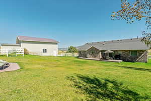 View of yard featuring a patio, an outbuilding, and a mountain view