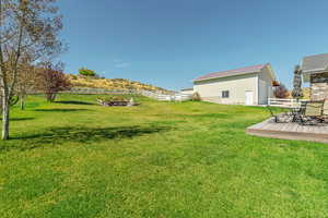View of yard featuring an outbuilding, a deck, a pole building, and a garage
