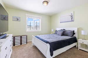 Bedroom featuring carpet and baseboards