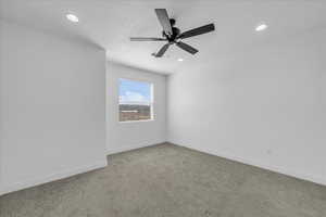 Empty room with carpet flooring, a ceiling fan, and recessed lighting