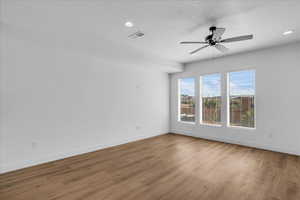 Spare room featuring a ceiling fan, wood finished floors, and recessed lighting