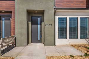 Property entrance featuring stucco siding and elevator