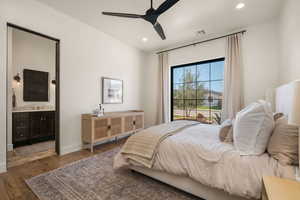 Bedroom featuring recessed lighting, dark wood-type flooring, ceiling fan, and connected bathroom