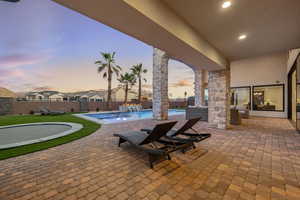 Patio terrace at dusk with a patio and a fenced backyard