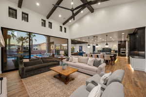Living room featuring light wood-type flooring, recessed lighting, and vaulted ceiling