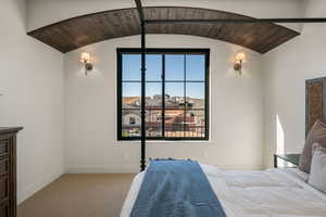 Bedroom featuring a barrel ceiling, light carpet, and wood ceiling