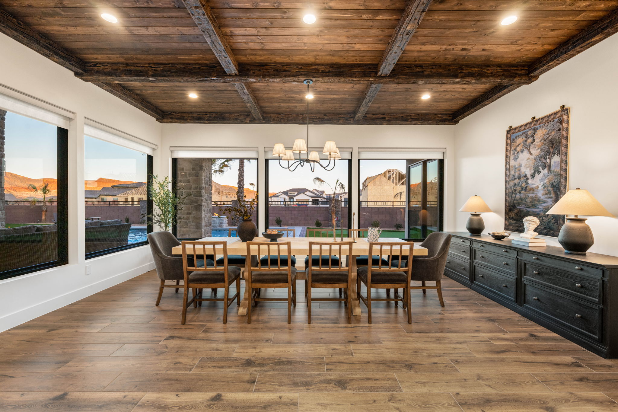 Dining space with a wooden ceiling with exposed beams, suspended lighting, and hardwood / wood-style floors