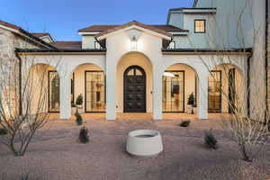 Rear view of property with stucco siding and a porch