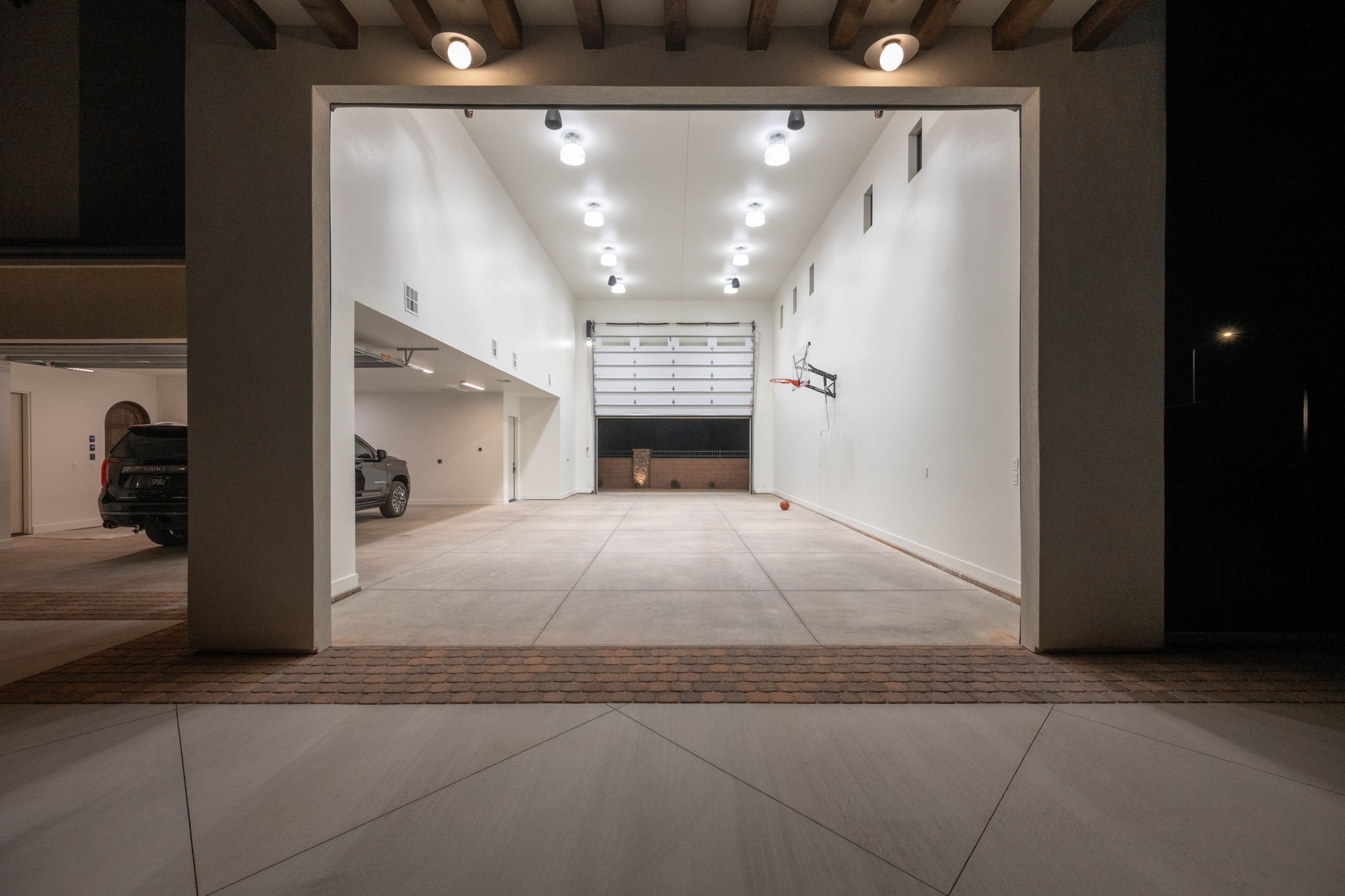 View of property's community with rail lighting and a high ceiling