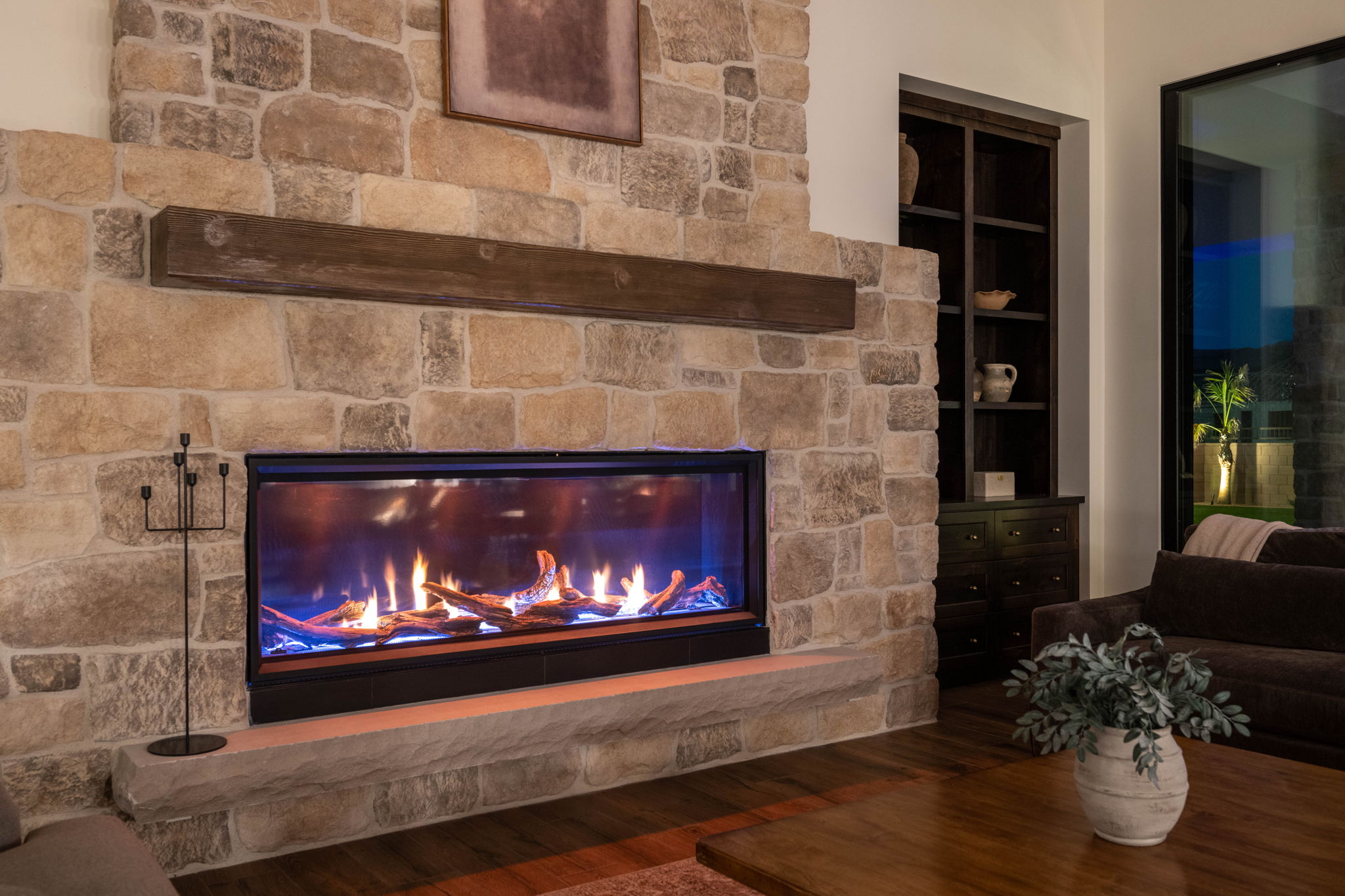 Detailed view of wood finished floors and a fireplace