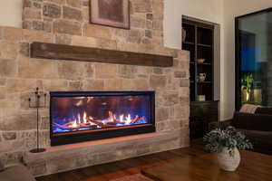 Detailed view of wood finished floors and a fireplace