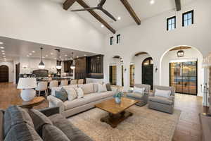 Living room featuring arched walkways, hardwood / wood-style flooring, recessed lighting, ceiling fan, and lofted ceiling