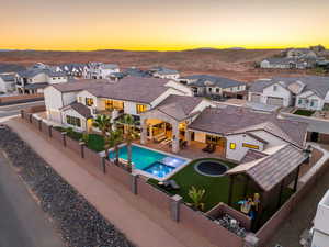 Relaxing pool / spa featuring a residential view, a patio, and a fenced backyard