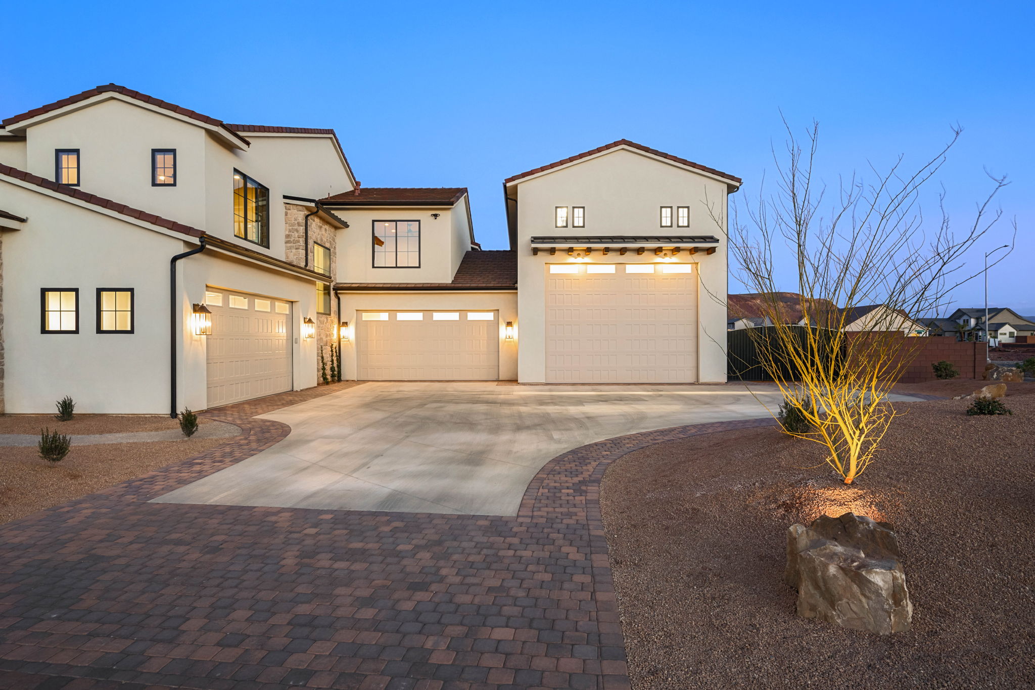 Mediterranean / spanish-style house with concrete driveway, an attached garage, and stucco siding