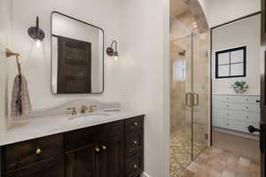 Bathroom with vanity and a stall shower