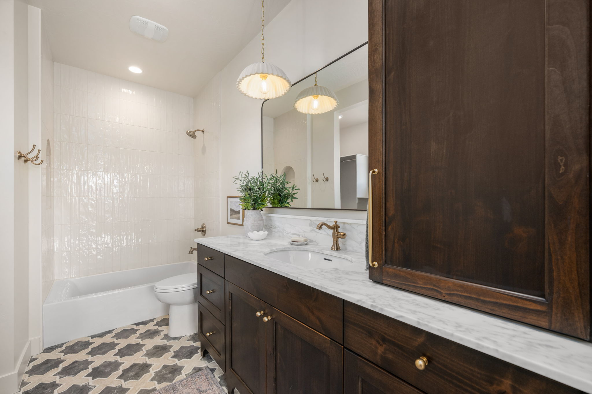 Bathroom with vanity, shower / bathtub combination, and recessed lighting