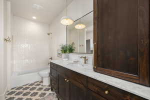 Bathroom with vanity, shower / bathtub combination, and recessed lighting
