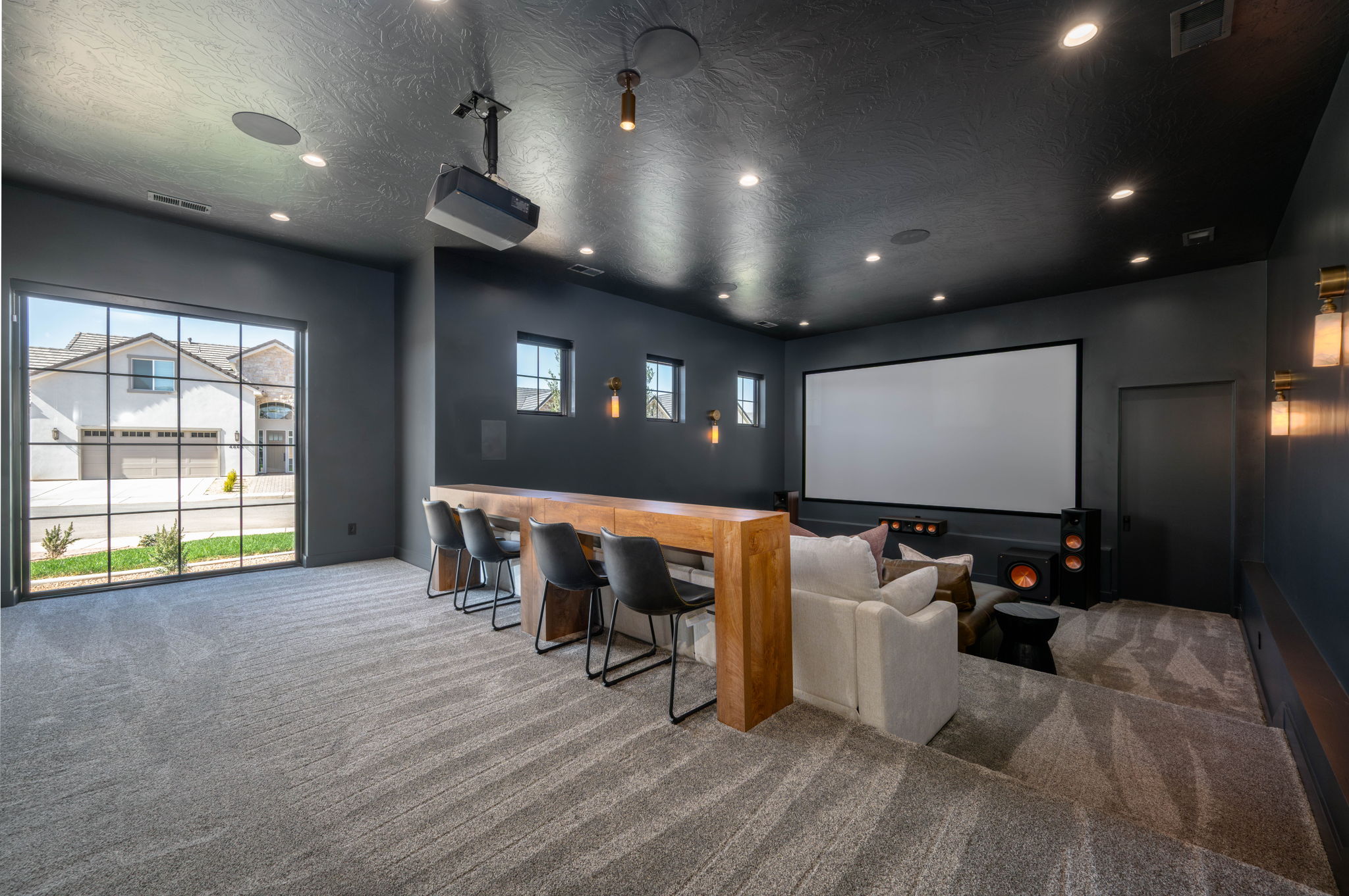 Cinema with carpet floors, a textured ceiling, and recessed lighting