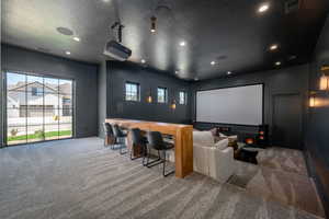 Cinema with carpet floors, a textured ceiling, and recessed lighting