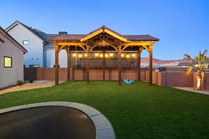 Fenced backyard with a patio area and a mountain view