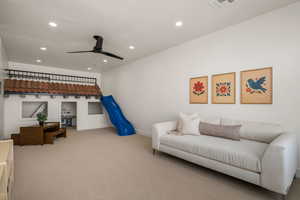 Living room with a ceiling fan, carpet flooring, and recessed lighting