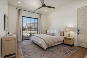Bedroom with access to outside, a ceiling fan, dark wood-style floors, and recessed lighting
