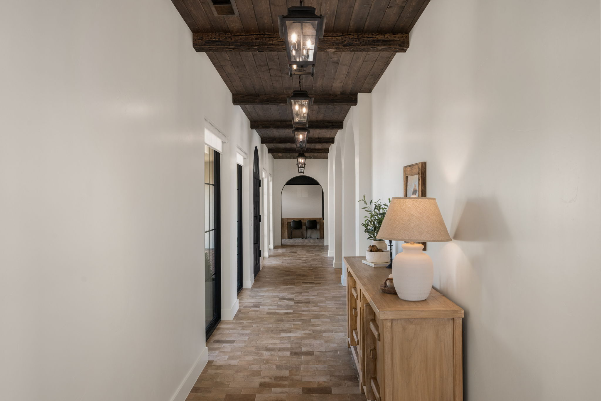 Hallway featuring arched walkways and wood ceiling