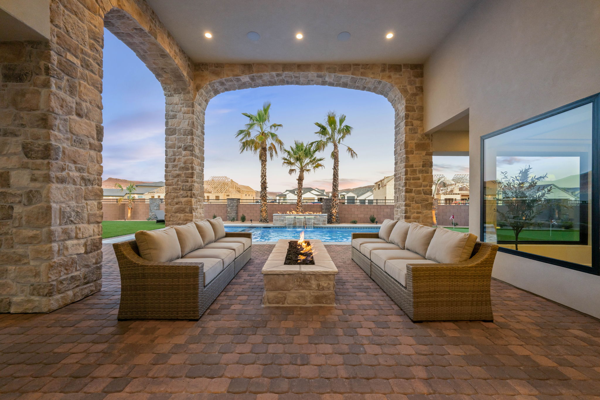 Fenced backyard with an outdoor living space with a fire pit and a patio area