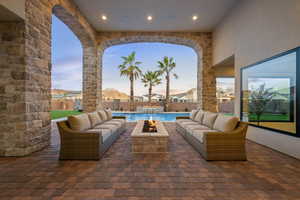Fenced backyard with an outdoor living space with a fire pit and a patio area