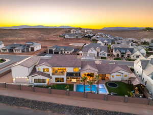 Aerial perspective of suburban area featuring a pool area and a mountainous background