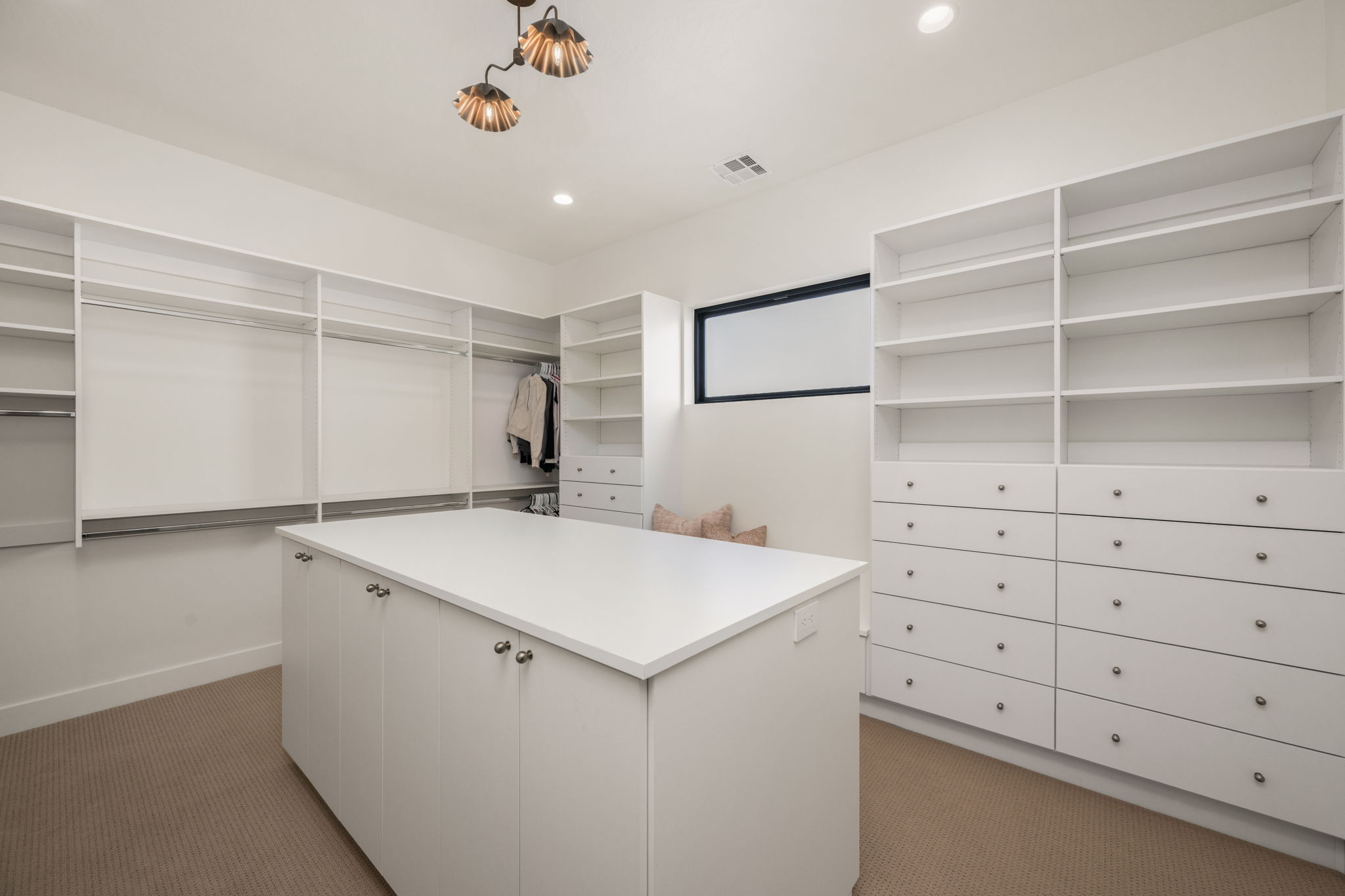 Walk in closet with dark carpet