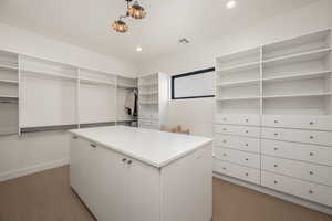 Walk in closet with dark carpet