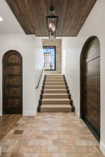 Entrance foyer with arched walkways and wooden ceiling