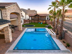 Integrated pool / hot tub featuring a fenced backyard and a patio area