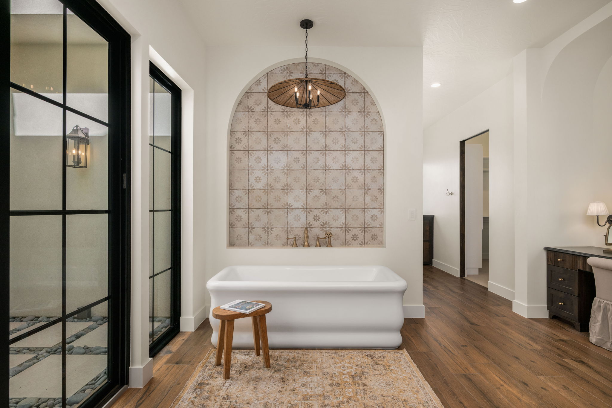 Bathroom with a freestanding tub, dark wood-type flooring, and vanity