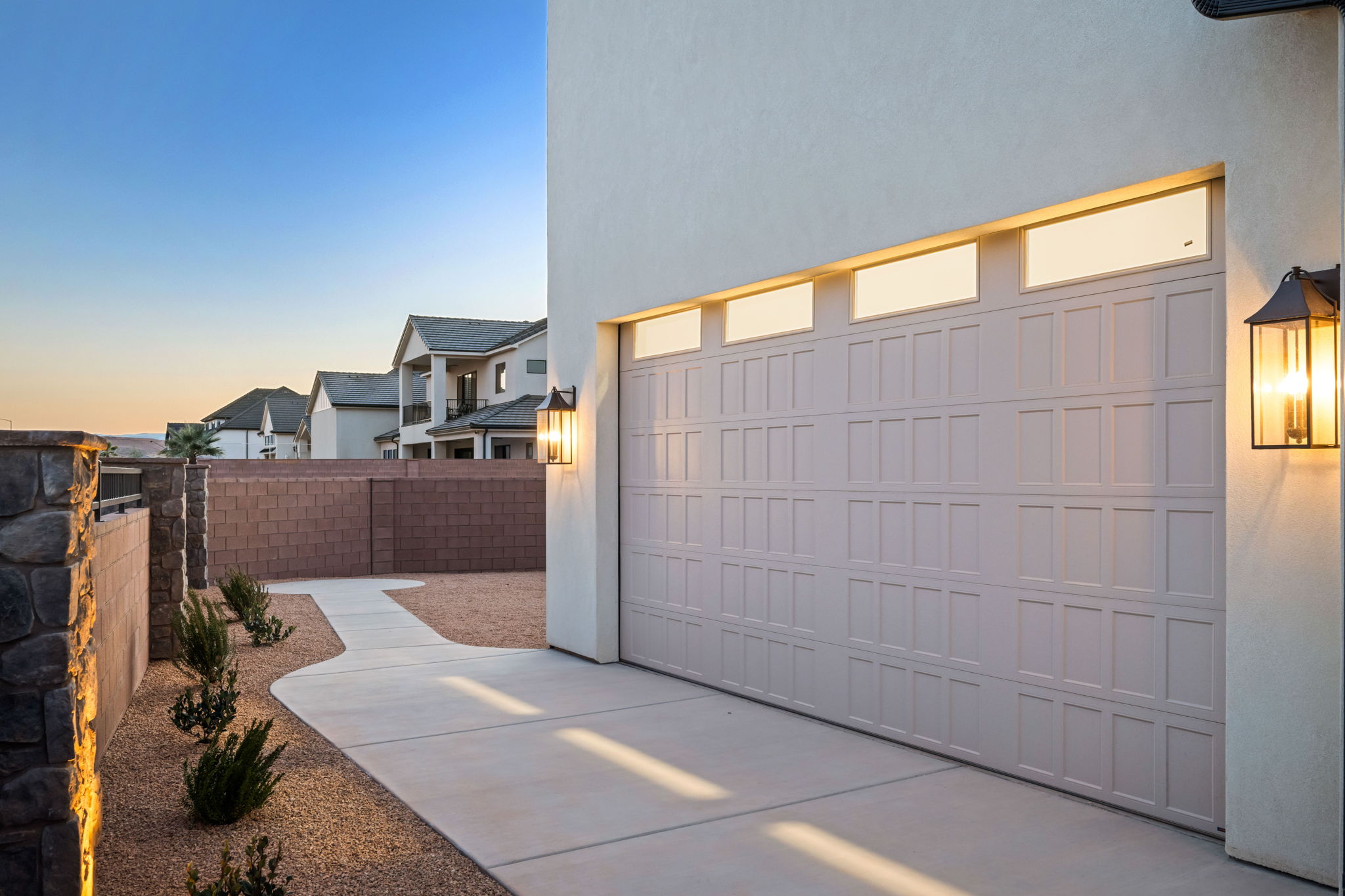 Garage at dusk with concrete driveway