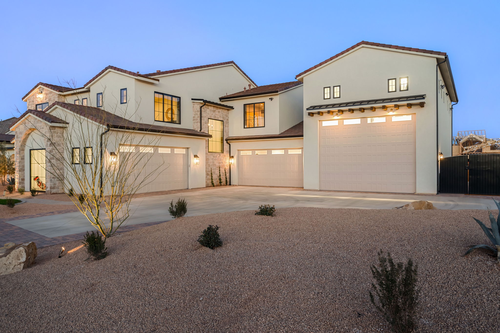 View of front of home featuring concrete driveway, stucco siding, and an attached garage