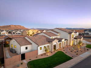 Mediterranean / spanish home featuring stucco siding, a residential view, a patio, and stone siding