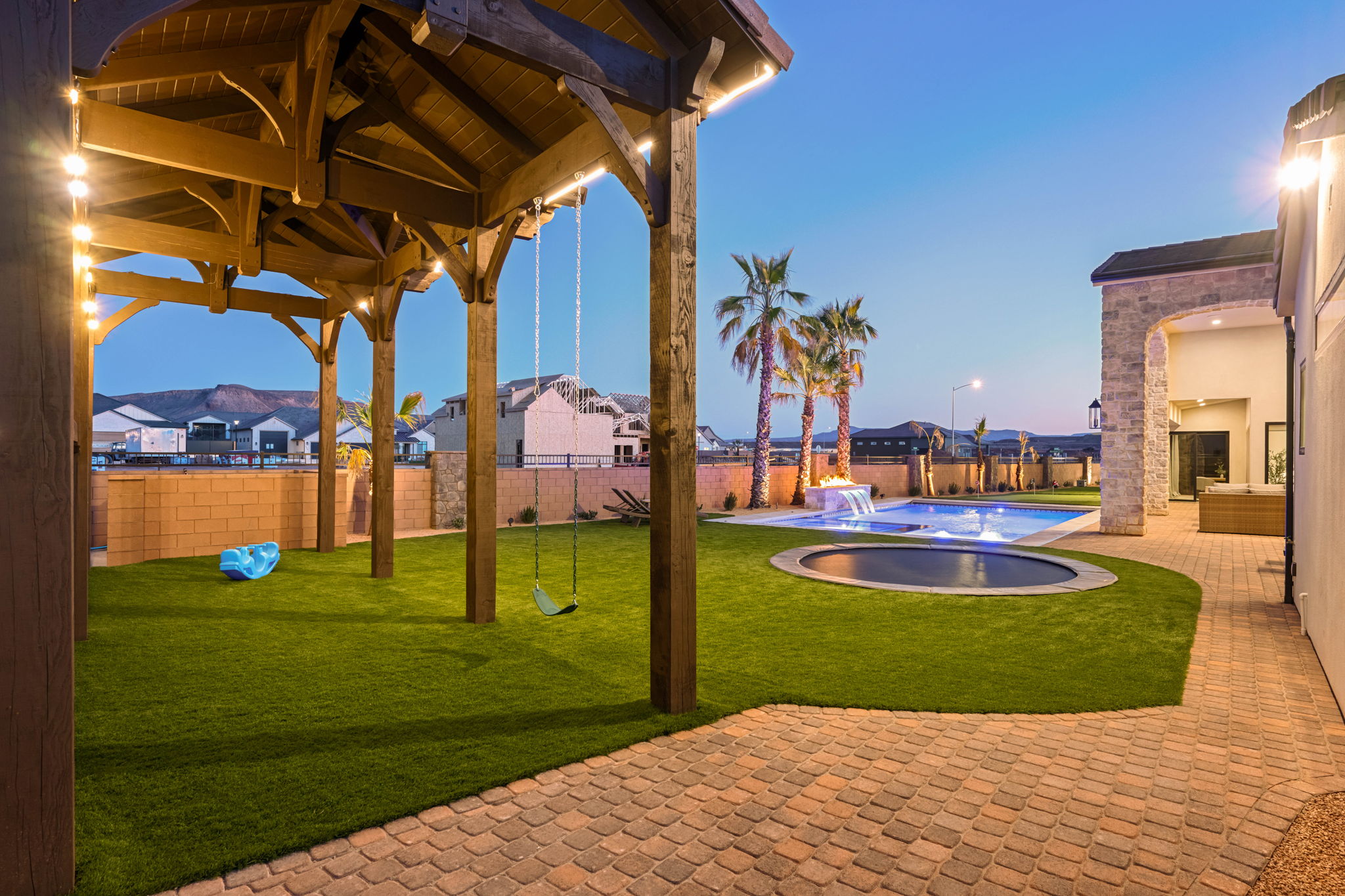 Patio terrace at dusk with a patio area, a residential view, and a fenced backyard