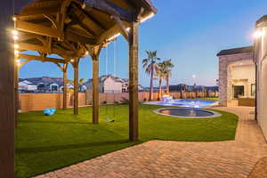 Patio terrace at dusk with a patio area, a residential view, and a fenced backyard