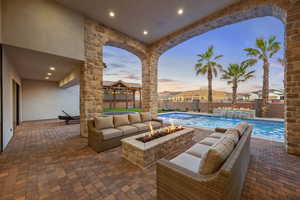 Fenced backyard with a patio area and an outdoor living space with a fire pit