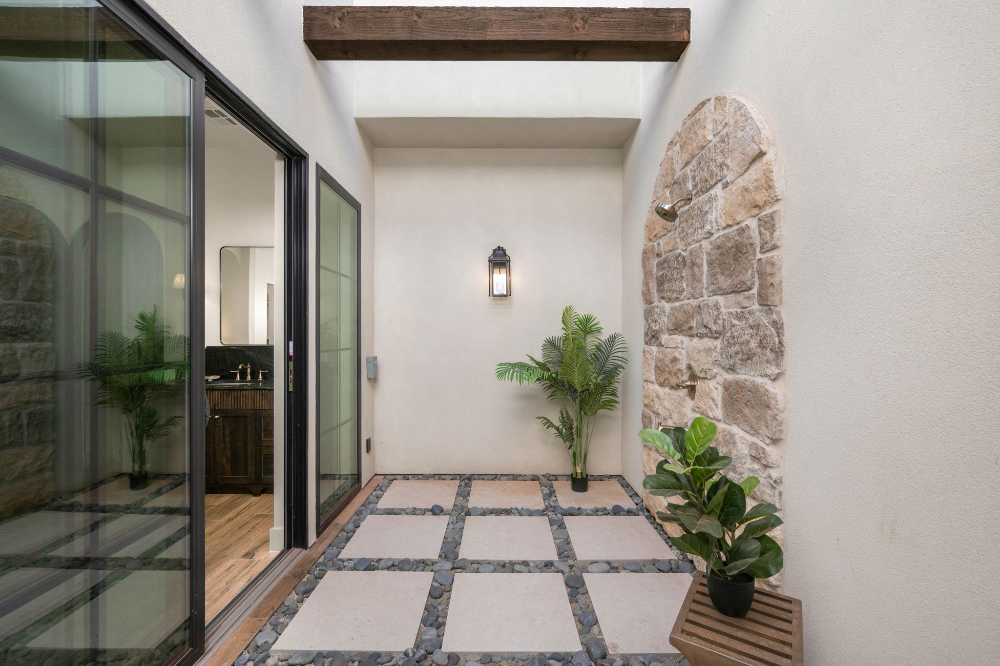 View of exterior entry with stucco siding and stone siding