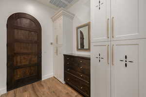 Foyer entrance with dark wood-style flooring and baseboards