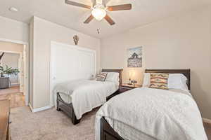 Bedroom with carpet flooring, a ceiling fan, and a closet
