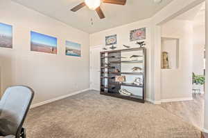 Unfurnished office featuring ceiling fan and light colored carpet