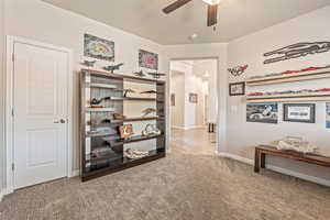 Bedroom with light colored carpet and ceiling fan