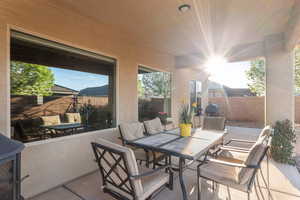 Fenced backyard with a patio area, outdoor dining space, and a grill